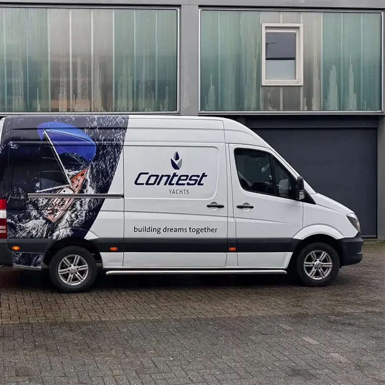 Witte Mercedes Sprinter met een full colour print van een zeiljacht op golven en het logo van Contest Yachts