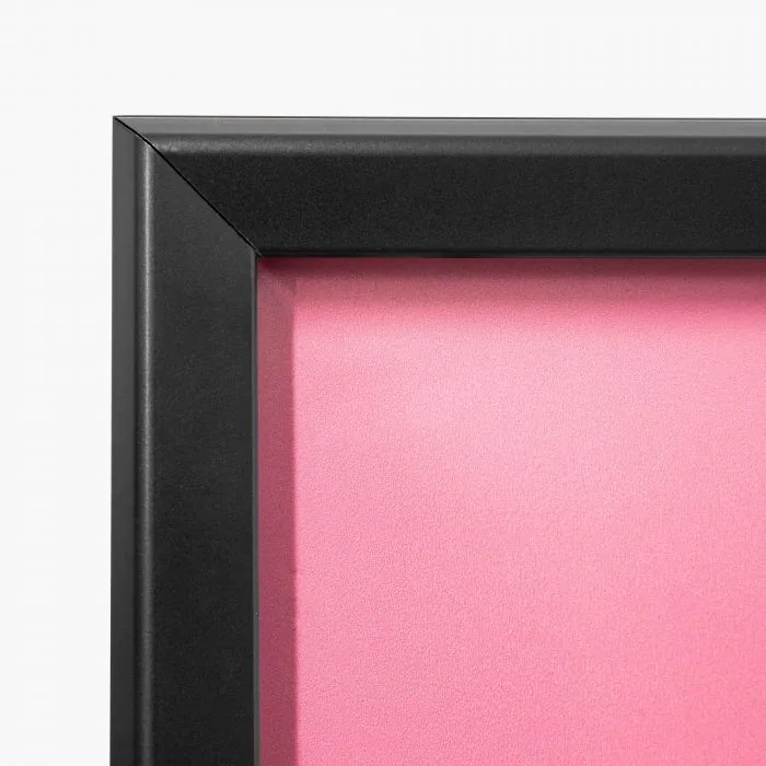 Stoepbord met zwart frame en roze poster, detail van de hoek